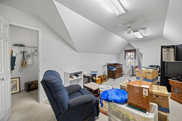 interior space featuring a ceiling fan, lofted ceiling, light colored carpet, and baseboards