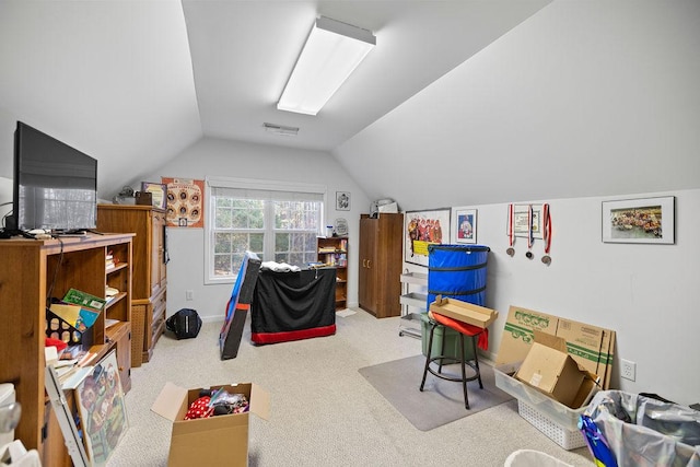 recreation room with light carpet, visible vents, and vaulted ceiling