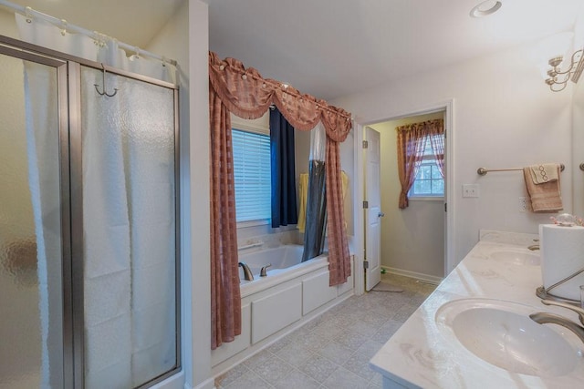 full bathroom featuring double vanity, a sink, a shower stall, and a bath