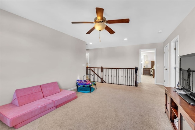 interior space with ceiling fan and light carpet