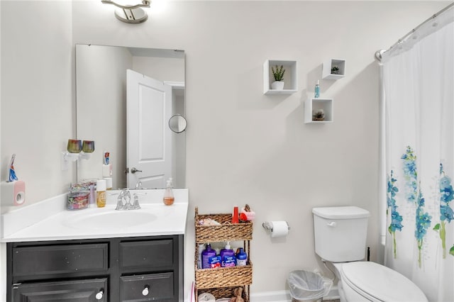 bathroom with toilet, vanity, and curtained shower