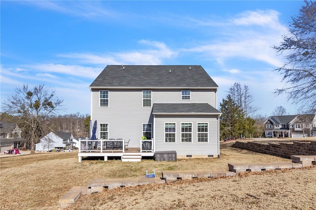 back of house featuring a yard and a deck