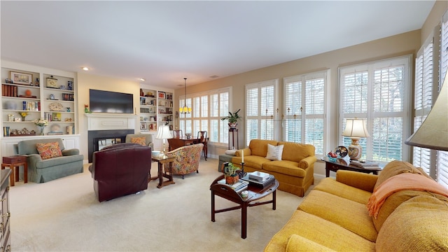 living room featuring light carpet and built in shelves