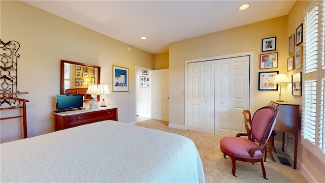 carpeted bedroom featuring multiple windows and a closet