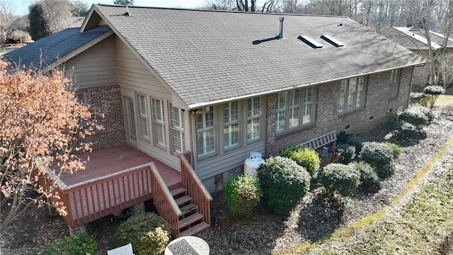 rear view of house with a wooden deck