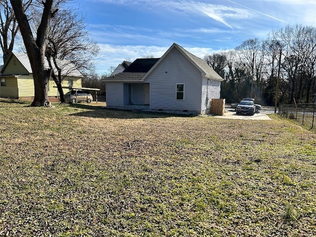 view of side of home with a lawn