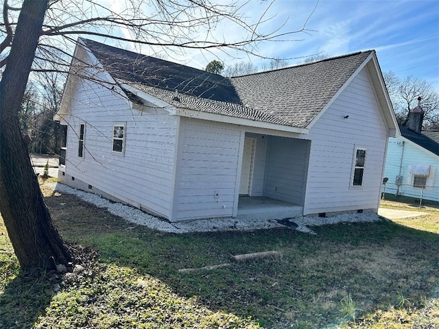 rear view of property featuring a yard