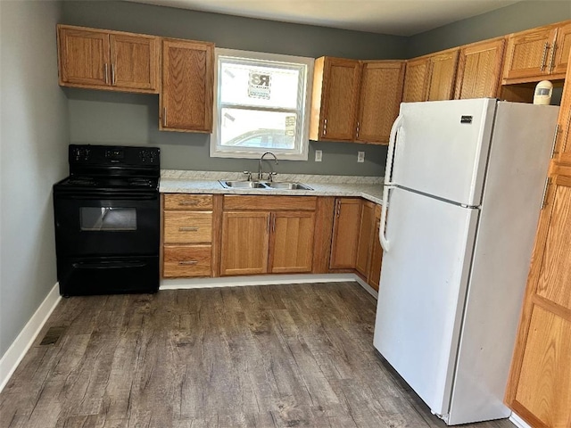 kitchen featuring electric range, white refrigerator, dark hardwood / wood-style floors, and sink