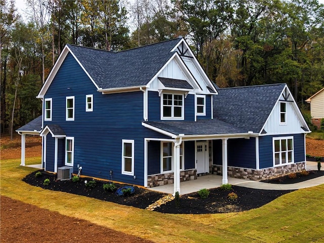 view of front of house with a patio, central AC unit, and a front lawn