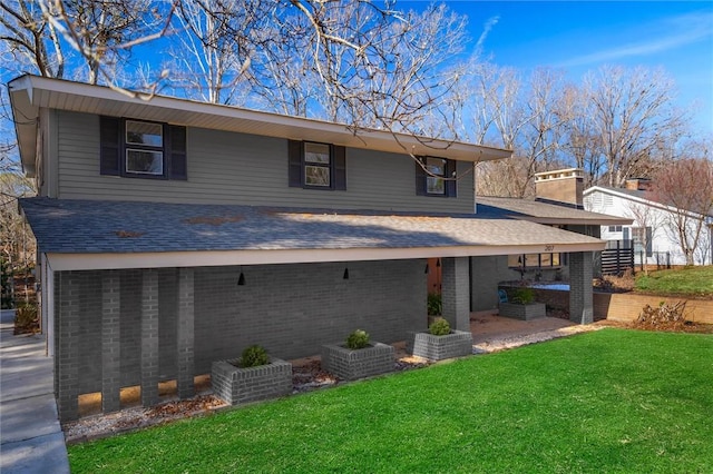 rear view of property with a yard