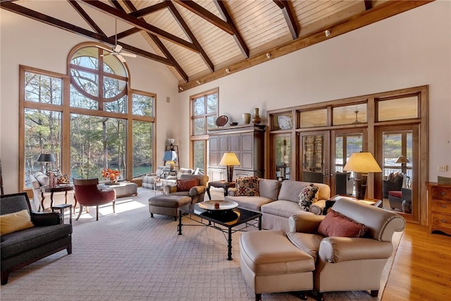 living room featuring ceiling fan, beamed ceiling, light hardwood / wood-style flooring, wood ceiling, and high vaulted ceiling