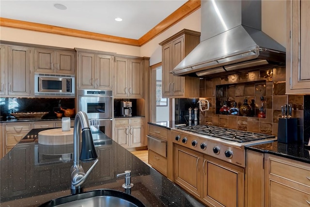 kitchen featuring appliances with stainless steel finishes, dark stone counters, backsplash, crown molding, and range hood