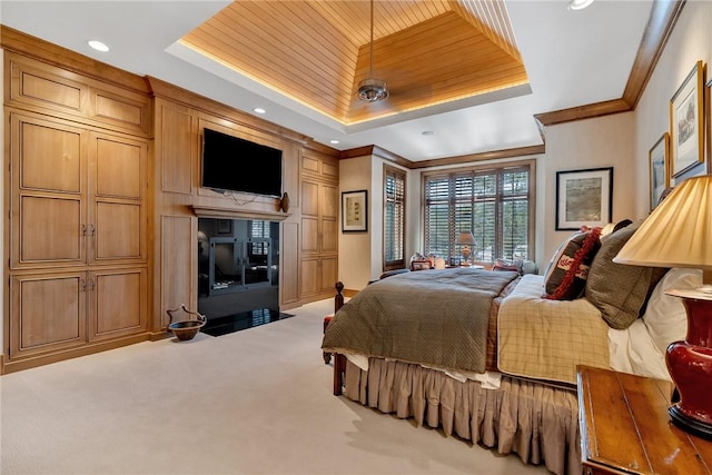 bedroom featuring crown molding, a raised ceiling, and carpet flooring