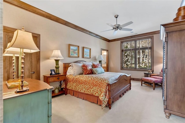 bedroom with ceiling fan, light carpet, and ornamental molding