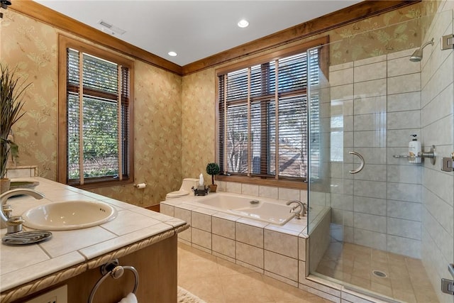 bathroom featuring vanity, a healthy amount of sunlight, and shower with separate bathtub