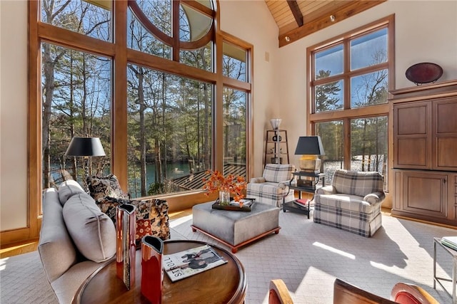 sunroom / solarium featuring wood ceiling, a water view, plenty of natural light, and lofted ceiling with beams