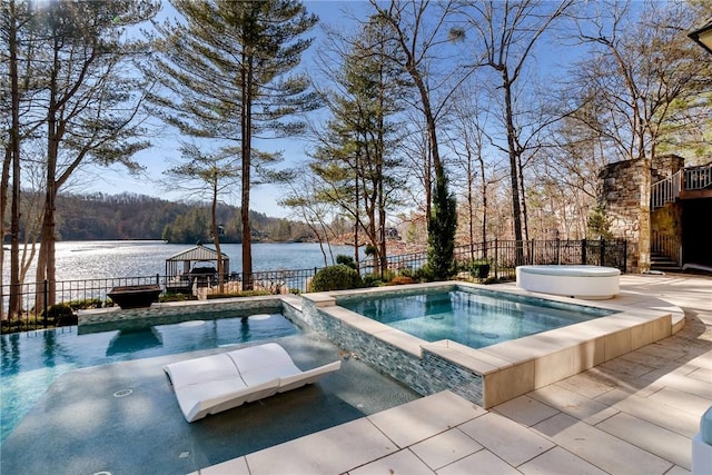 view of swimming pool featuring a water view, a gazebo, a patio area, and an in ground hot tub