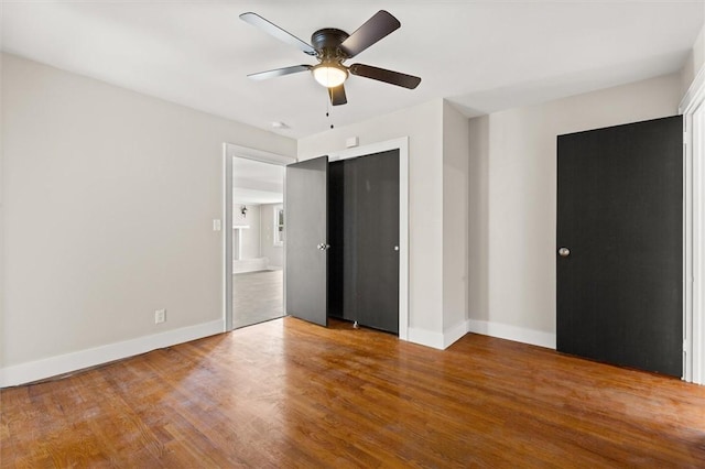 unfurnished bedroom with hardwood / wood-style floors, a closet, and ceiling fan