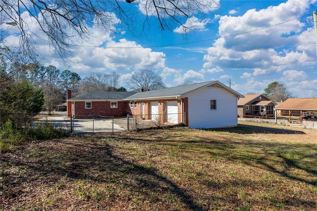 rear view of property featuring a lawn