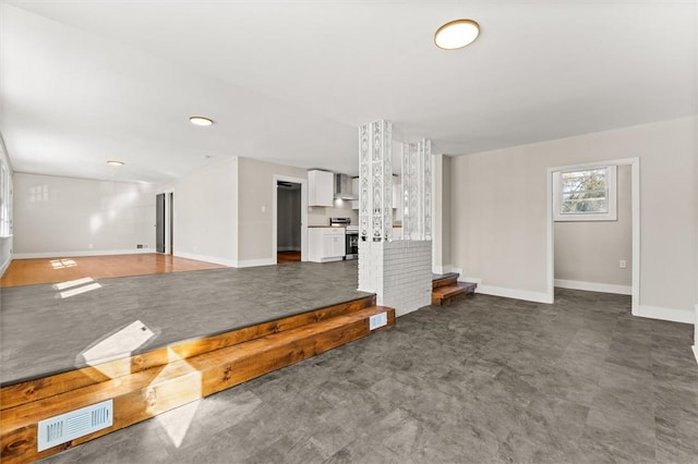 unfurnished living room featuring dark colored carpet