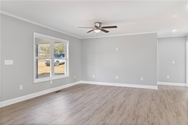 empty room featuring ceiling fan, ornamental molding, and wood-type flooring