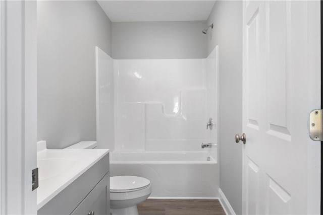 full bathroom with toilet, shower / bathtub combination, hardwood / wood-style floors, and vanity