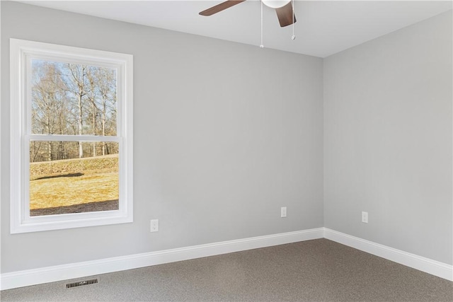 unfurnished room with ceiling fan and carpet floors