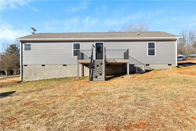 back of house featuring a deck and a yard