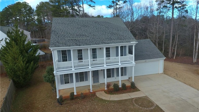 view of front of house featuring a balcony and a garage