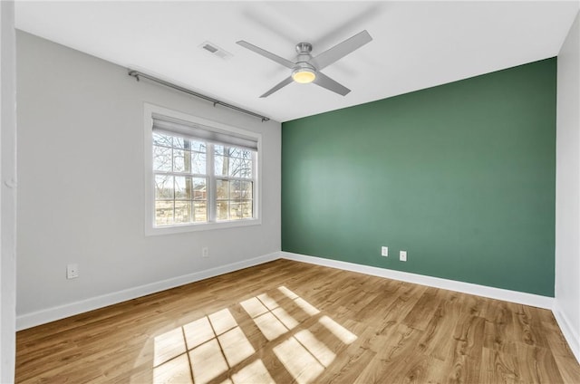 spare room featuring ceiling fan and light hardwood / wood-style floors