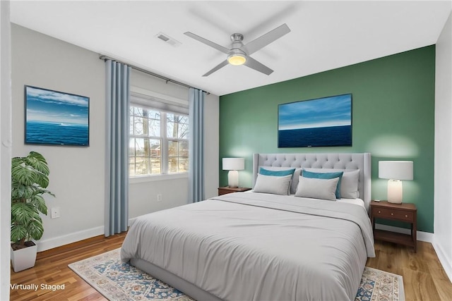 bedroom with ceiling fan and hardwood / wood-style flooring