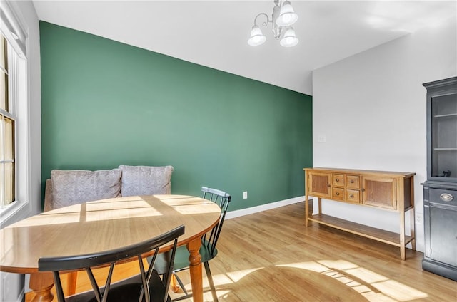 interior space featuring a chandelier, a healthy amount of sunlight, and light hardwood / wood-style flooring