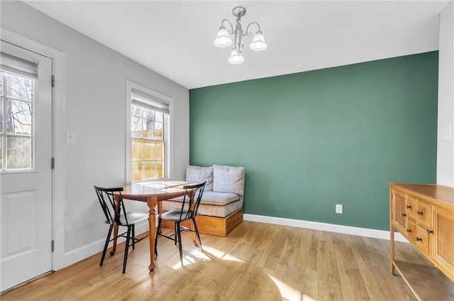 dining room featuring an inviting chandelier and light hardwood / wood-style flooring