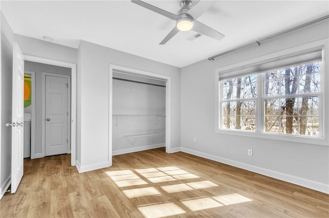 unfurnished bedroom featuring ceiling fan, light wood-type flooring, and a closet