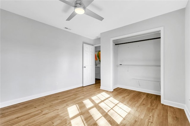 unfurnished bedroom featuring ceiling fan, light hardwood / wood-style flooring, and a closet