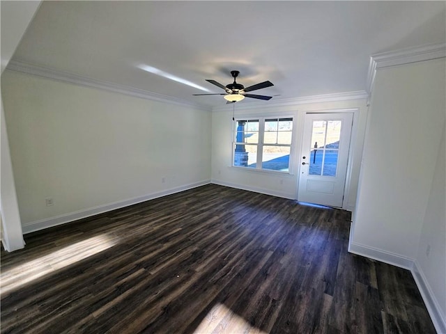 interior space with ornamental molding, ceiling fan, and dark wood-type flooring