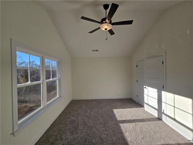 interior space with carpet flooring, ceiling fan, and vaulted ceiling