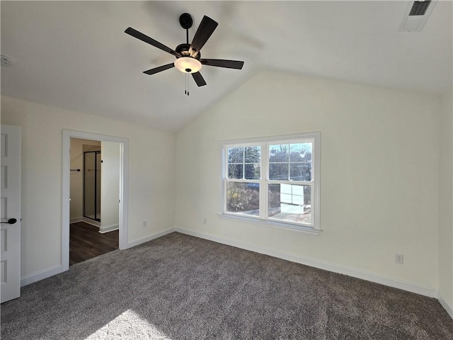 interior space featuring vaulted ceiling, ceiling fan, and dark carpet