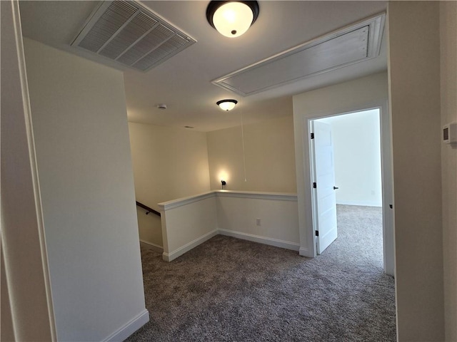 unfurnished room with dark carpet