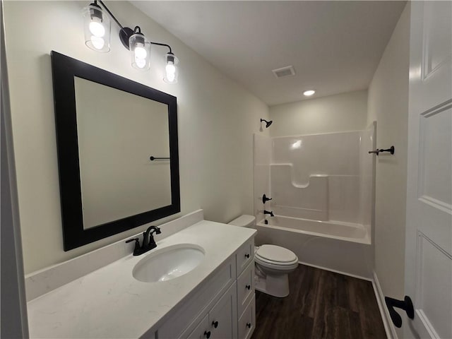 full bathroom featuring bathtub / shower combination, toilet, vanity, and hardwood / wood-style flooring