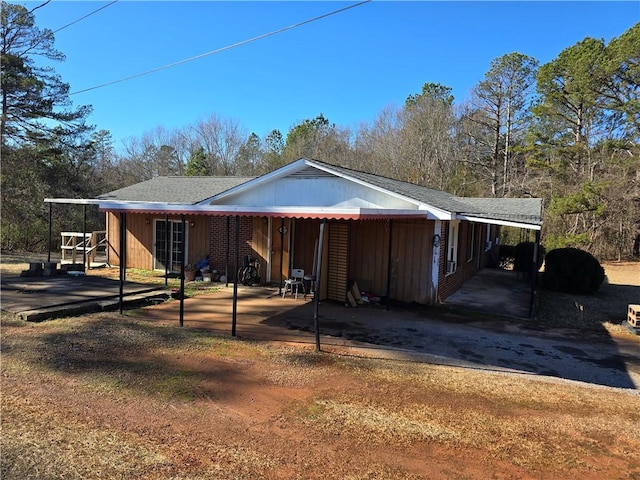 view of side of property featuring a carport