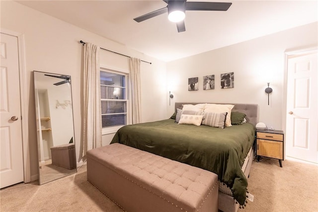 bedroom with ceiling fan and light carpet