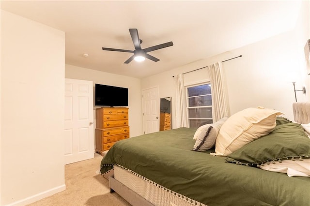 bedroom featuring ceiling fan and light carpet