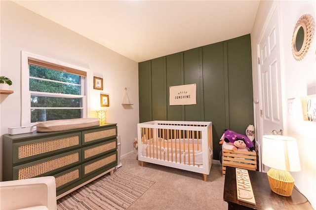 bedroom with light colored carpet and a crib