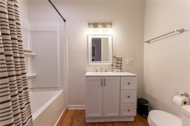 full bathroom featuring shower / tub combo, hardwood / wood-style floors, vanity, and toilet