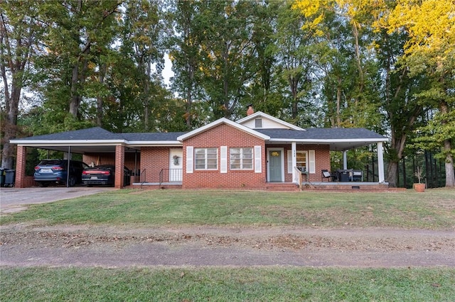 view of front of home with a front yard, a porch, and a carport