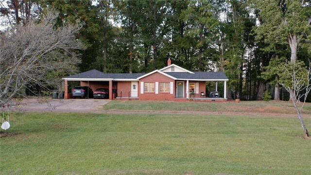 ranch-style house with covered porch, a front yard, and a carport