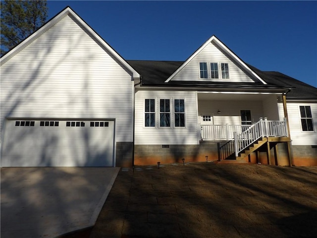 view of front facade featuring covered porch and a garage