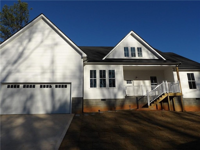 view of front of property with a porch and a garage