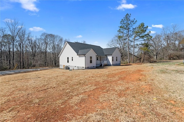 view of home's exterior with crawl space and a yard